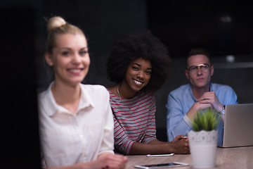 Image showing Multiethnic startup business team in night office