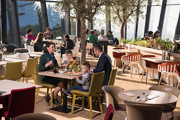 Image showing Young parents enjoying lunch time with their children