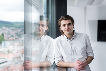 Image showing young businessman in startup office by the window