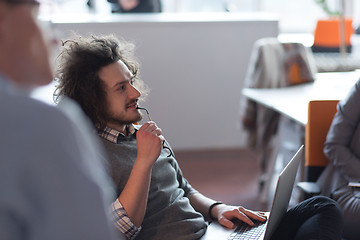 Image showing businessman working using a laptop in startup office