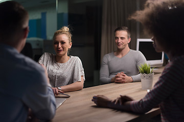 Image showing Multiethnic startup business team in night office