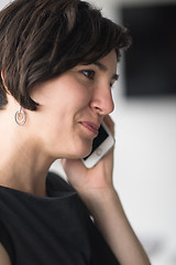 Image showing Elegant Woman Using Mobile Phone in office building