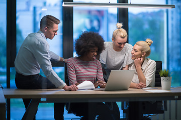 Image showing Multiethnic startup business team in night office