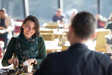 Image showing Closeup shot of young woman and man having meal.