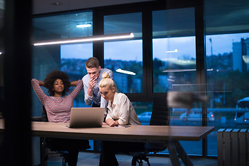 Image showing Multiethnic startup business team in night office