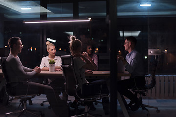 Image showing Multiethnic startup business team in night office