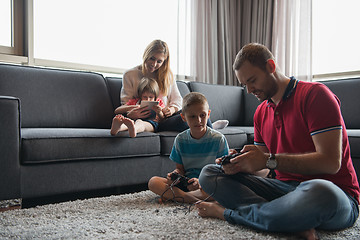 Image showing Happy family playing a video game