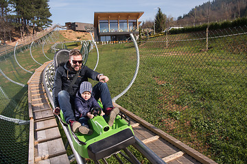 Image showing father and son enjoys driving on alpine coaster