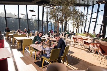 Image showing Young parents enjoying lunch time with their children