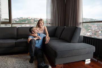 Image showing young handsome couple hugging on the sofa