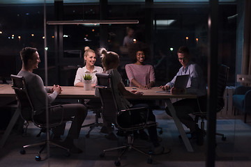 Image showing Multiethnic startup business team in night office