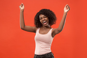 Image showing Winning success woman happy ecstatic celebrating being a winner. Dynamic energetic image of female afro model