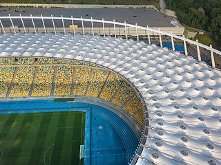 Image showing KYIV, UKRAINE - July 19, 2018. Aerial view from drone of construction of the stadium cover, green football field, tribunes of NSC Olimpiysky.