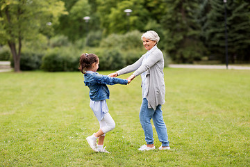 Image showing grandmother and granddaughter playing at park