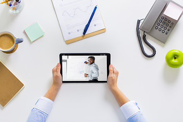 Image showing hands of businesswoman watching webinar on tablet