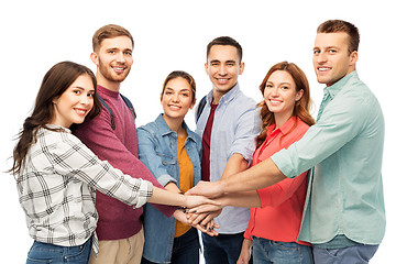 Image showing group of smiling friends stacking hands