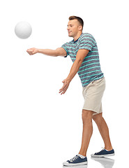 Image showing smiling young man playing volleyball