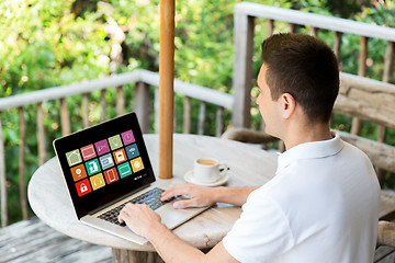 Image showing man with smart home icons on laptop computer