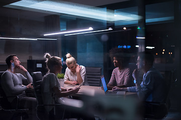 Image showing Multiethnic startup business team in night office