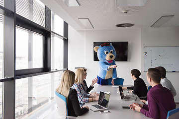 Image showing boss dresed as bear having fun with business people in trendy of