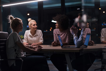 Image showing Multiethnic startup business team in night office