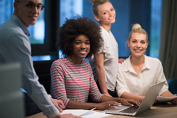 Image showing Multiethnic startup business team in night office