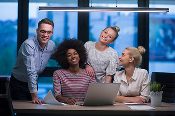 Image showing Multiethnic startup business team in night office