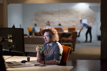 Image showing man working on computer in dark office