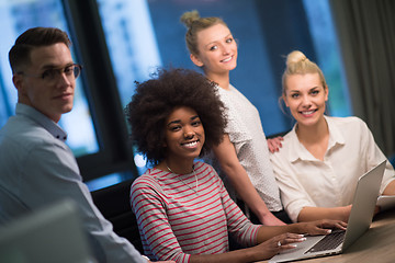 Image showing Multiethnic startup business team in night office