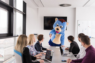 Image showing boss dresed as bear having fun with business people in trendy of