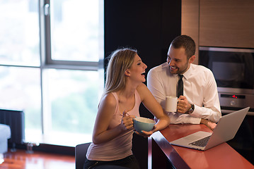 Image showing A young couple is preparing for a job and using a laptop