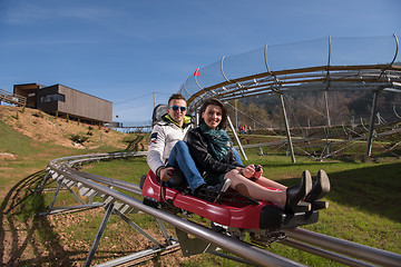 Image showing couple enjoys driving on alpine coaster