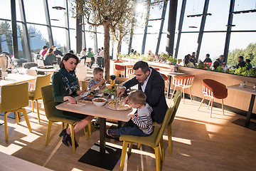 Image showing Young parents enjoying lunch time with their children