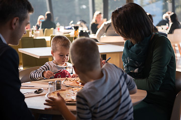 Image showing Young parents enjoying lunch time with their children