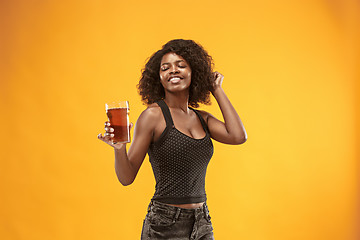 Image showing Sexy young afro woman drinking beer, not isolated on white background