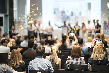 Image showing Young business team receiving award at best business project competition event.