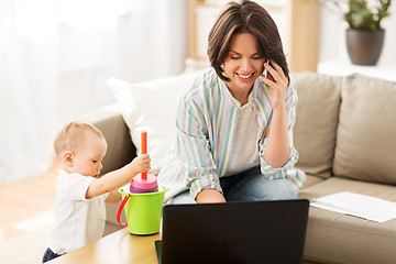 Image showing working mother with baby calling on smartphone