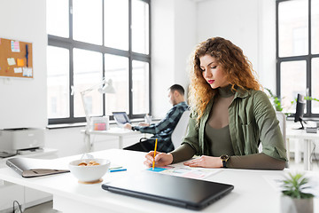 Image showing creative woman working on user interface at office