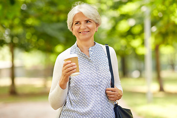 Image showing senior woman drinking takeaway coffee at park