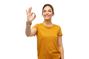 Image showing happy smiling young woman showing ok hand sign