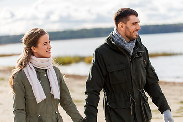 Image showing couple walking along autumn beach