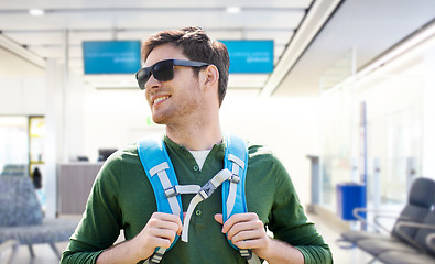 Image showing smiling man with backpack over airport terminal