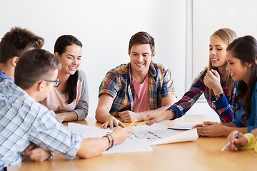 Image showing group of smiling students with blueprint