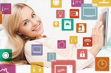 Image showing woman with tablet computer and smart home icons