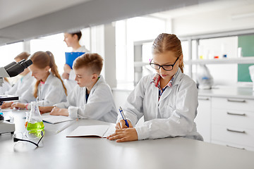 Image showing teacher and students studying chemistry at school