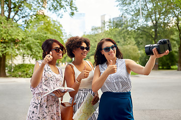 Image showing women with map travelling and recording video blog