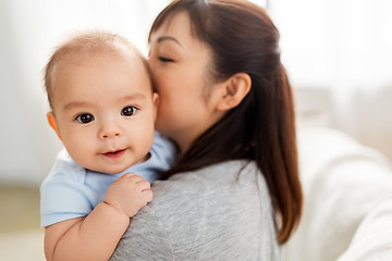 Image showing close up of happy mother kissing baby son at home