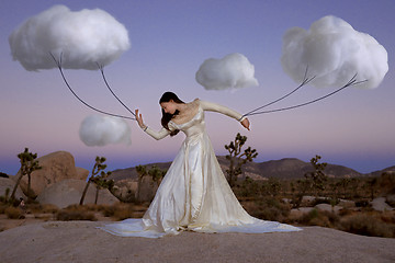 Image showing Abstract Concept of Girl Attached to Clouds Representing Fantasy