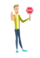 Image showing Young caucasian businessman holding stop road sign