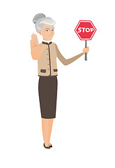 Image showing Caucasian business woman holding stop road sign.